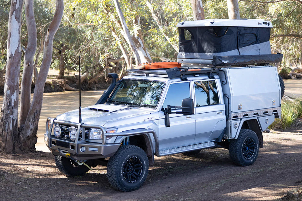 Silver Toyota 79 Series with canopy and rooftop touring setup