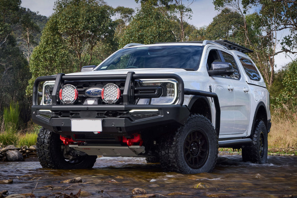 White Ford 4x4 complete touring build in a creek